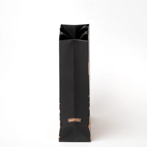 Matte black paper gift bag with minimalist design
